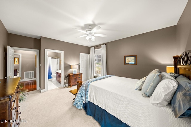 bedroom with baseboards, visible vents, connected bathroom, ceiling fan, and carpet flooring