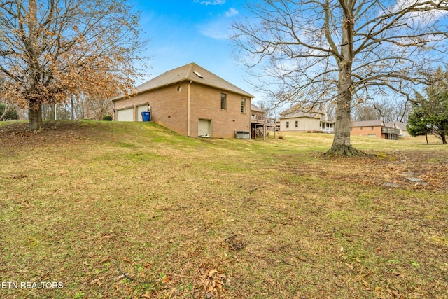 view of yard with a deck and a garage