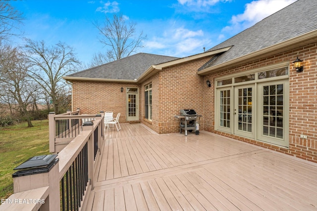 wooden terrace featuring french doors and area for grilling