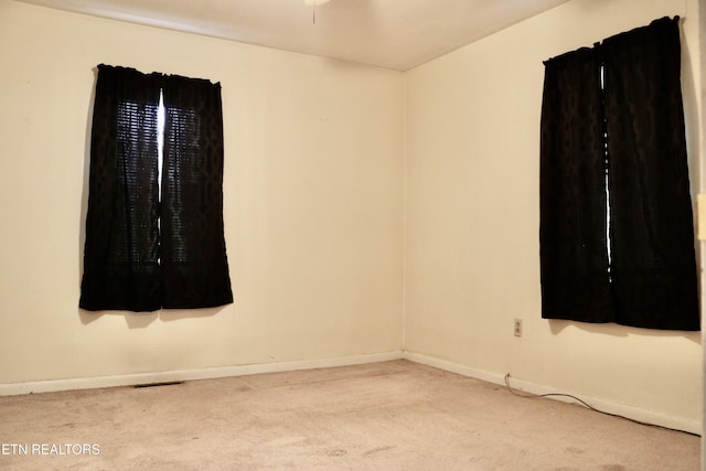 carpeted empty room with baseboards