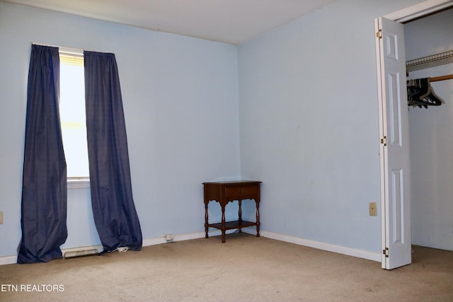 interior space featuring carpet and baseboards