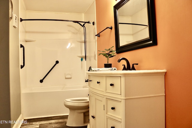 bathroom with vanity, shower / tub combination, wood finished floors, and toilet