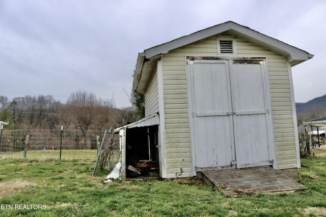 view of shed featuring fence