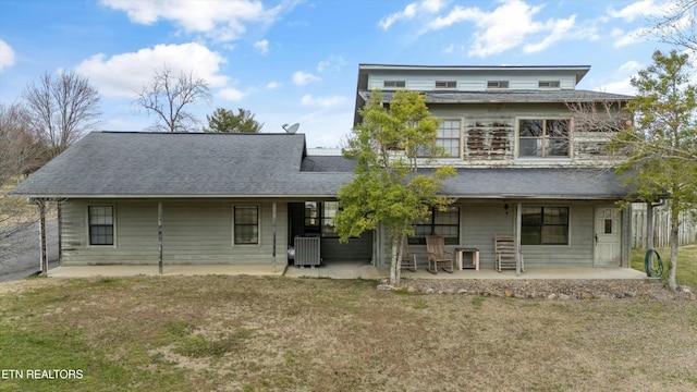 back of house featuring a patio, a yard, central AC, and roof with shingles