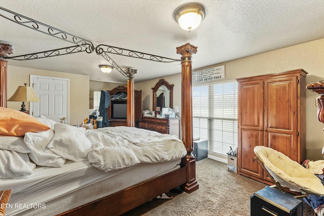 bedroom with light carpet and a textured ceiling