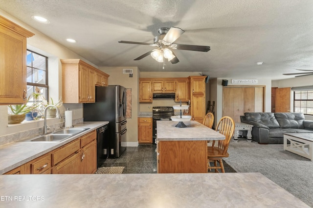 kitchen with range hood, electric range oven, open floor plan, a sink, and dishwasher