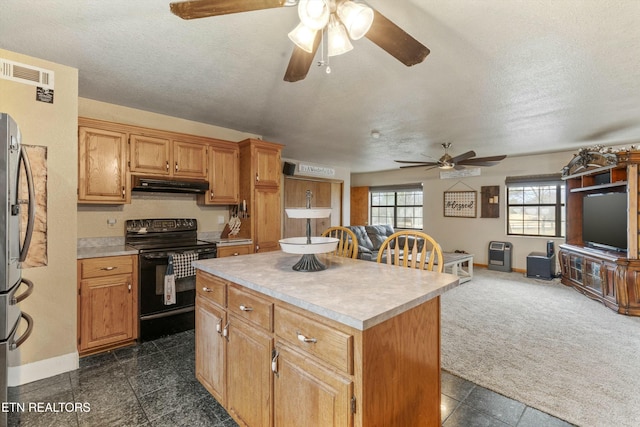 kitchen featuring under cabinet range hood, electric range, visible vents, open floor plan, and a center island