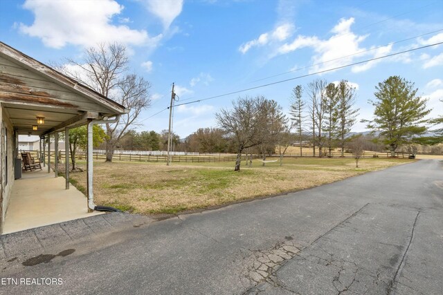 view of yard with a rural view and fence