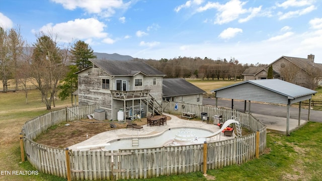 back of house featuring a deck, a patio, stairway, and a fenced backyard