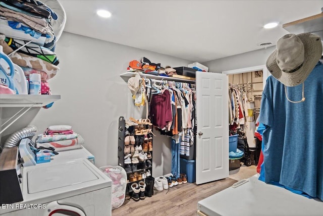 spacious closet with wood finished floors and washing machine and clothes dryer