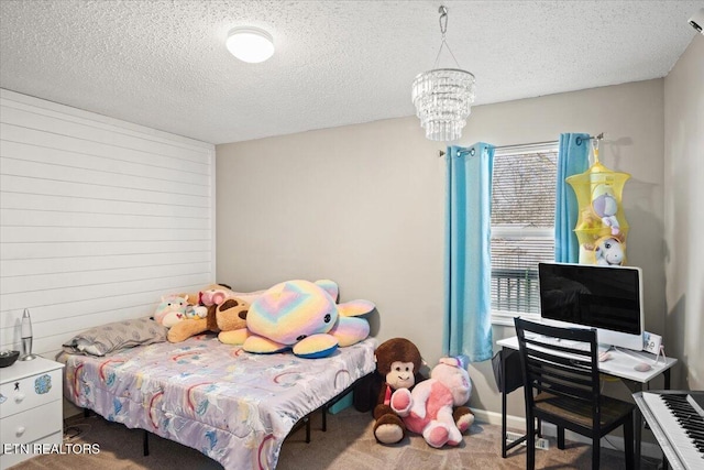 bedroom featuring multiple windows, a textured ceiling, and carpet