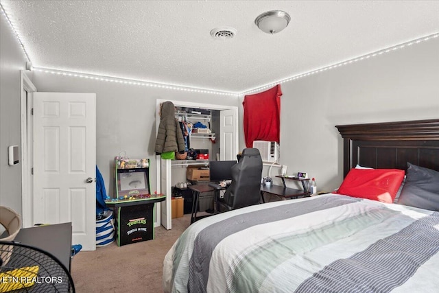 bedroom with visible vents, carpet, cooling unit, a closet, and a textured ceiling