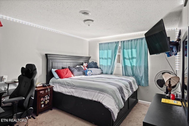 bedroom with visible vents, baseboards, light colored carpet, and a textured ceiling