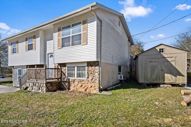 exterior space with cooling unit, an outdoor structure, a storage unit, stone siding, and a lawn