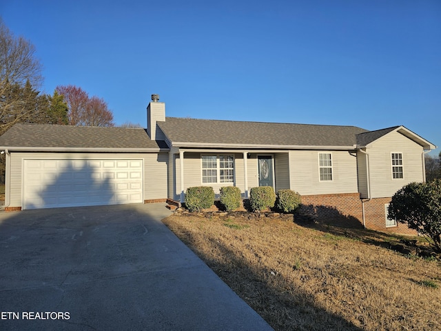 ranch-style home featuring a garage, a chimney, concrete driveway, and roof with shingles