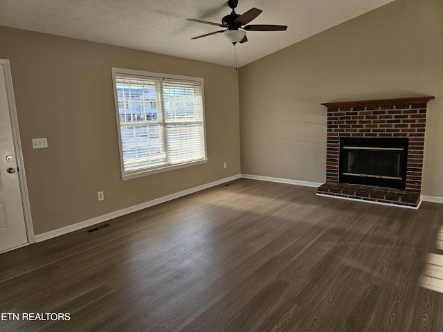 unfurnished living room featuring dark wood-type flooring, a fireplace, a ceiling fan, and baseboards