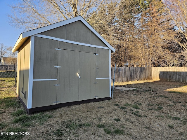 view of shed with a fenced backyard