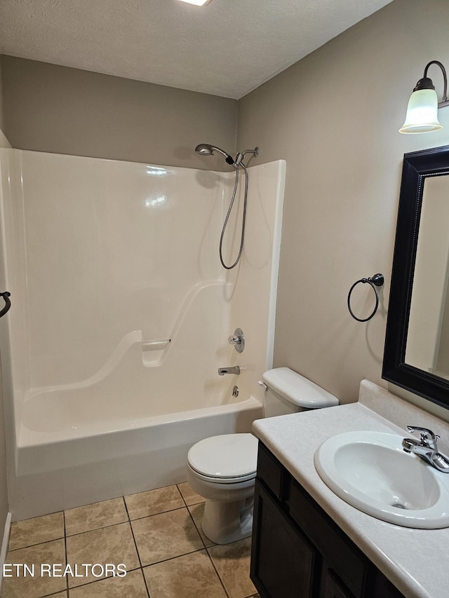 full bath with a textured ceiling, shower / washtub combination, tile patterned flooring, and toilet