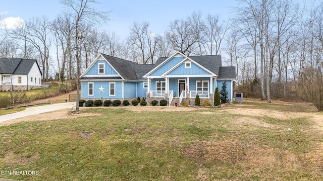 view of front facade featuring covered porch, a front lawn, and board and batten siding