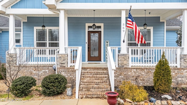 doorway to property with covered porch and board and batten siding