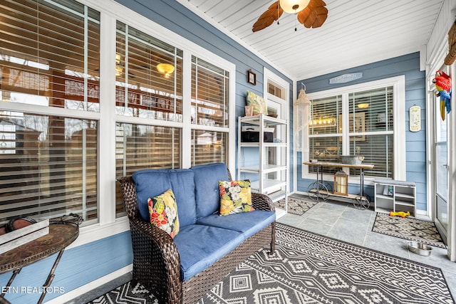 sunroom featuring a ceiling fan