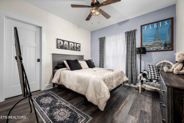 bedroom featuring a ceiling fan and dark wood-type flooring