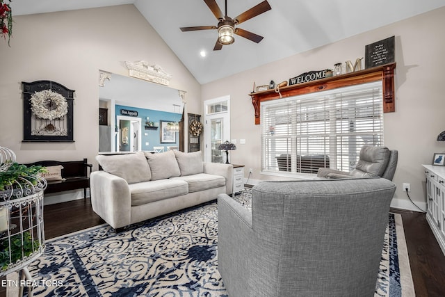 living area featuring dark wood-style floors, baseboards, high vaulted ceiling, and a ceiling fan