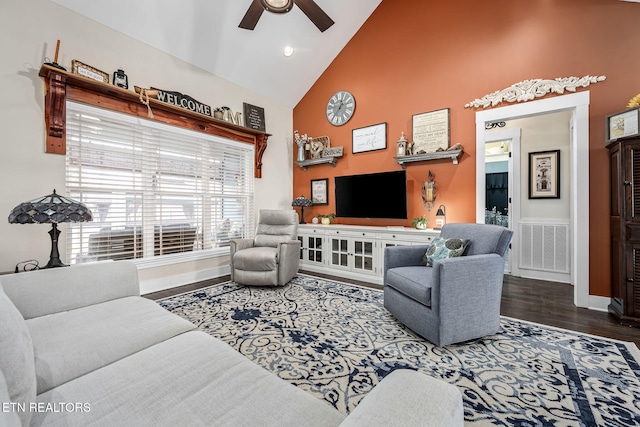 living area with a ceiling fan, visible vents, high vaulted ceiling, and wood finished floors