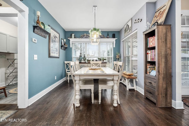 dining space with a notable chandelier, dark wood-style flooring, and baseboards