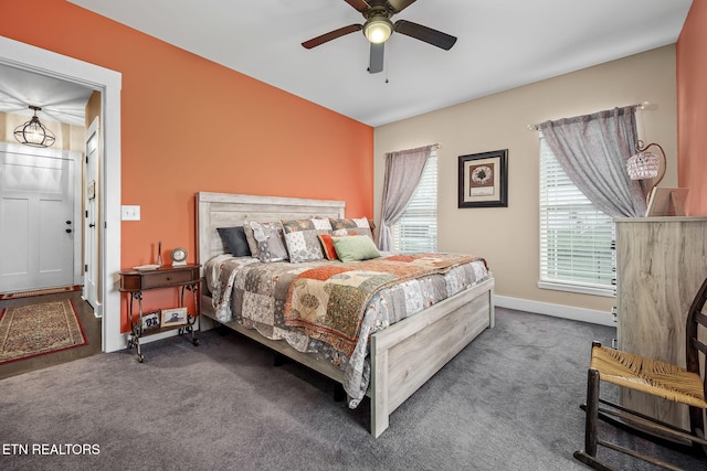 bedroom featuring multiple windows, baseboards, and carpet flooring