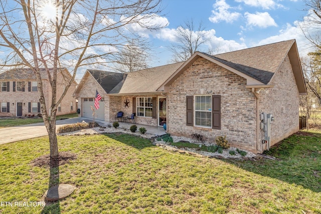 view of front of house featuring a garage, driveway, brick siding, and a front yard