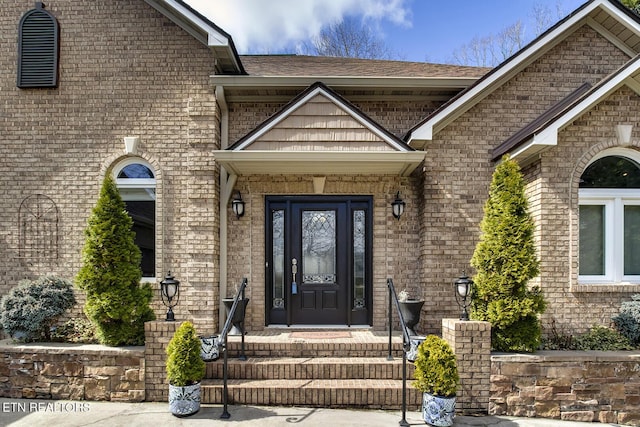 property entrance with brick siding