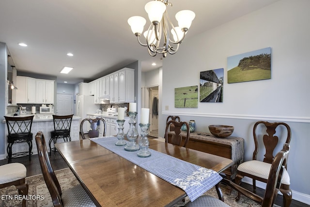 dining room with recessed lighting, dark wood-style flooring, and a notable chandelier