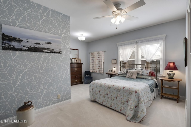 carpeted bedroom with baseboards and a ceiling fan