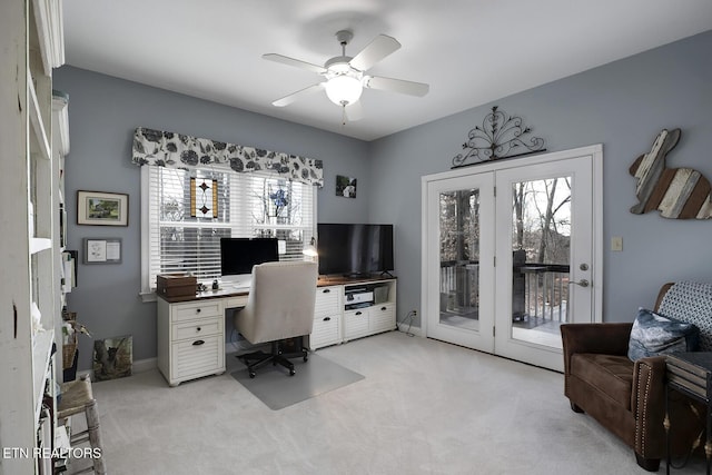 office space with ceiling fan, plenty of natural light, and light colored carpet