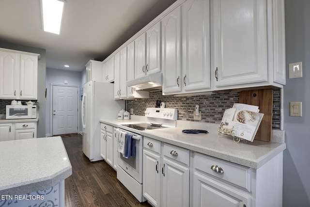 kitchen with white appliances, white cabinetry, and under cabinet range hood