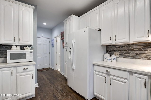 kitchen featuring white appliances, dark wood-style flooring, backsplash, and white cabinets