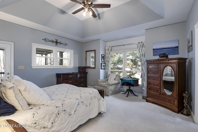 bedroom featuring lofted ceiling, ceiling fan, access to exterior, carpet, and a raised ceiling