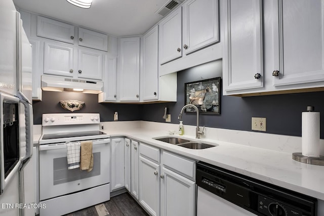 kitchen with white appliances, a sink, white cabinetry, and under cabinet range hood