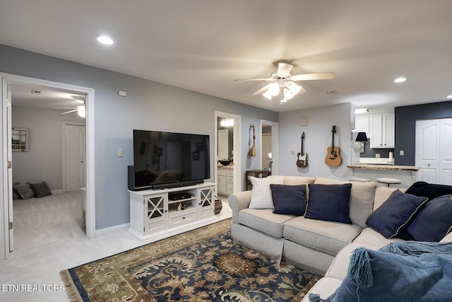 living room with recessed lighting, light colored carpet, ceiling fan, and baseboards