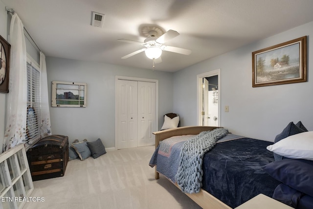 bedroom featuring carpet floors, a closet, visible vents, and a ceiling fan