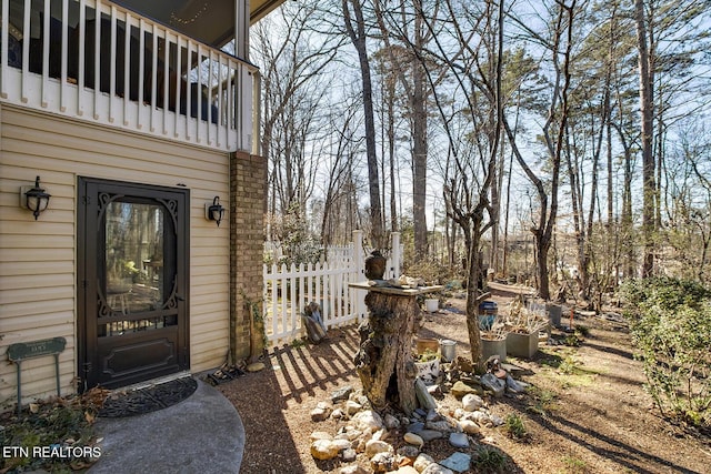 view of yard with a balcony and fence