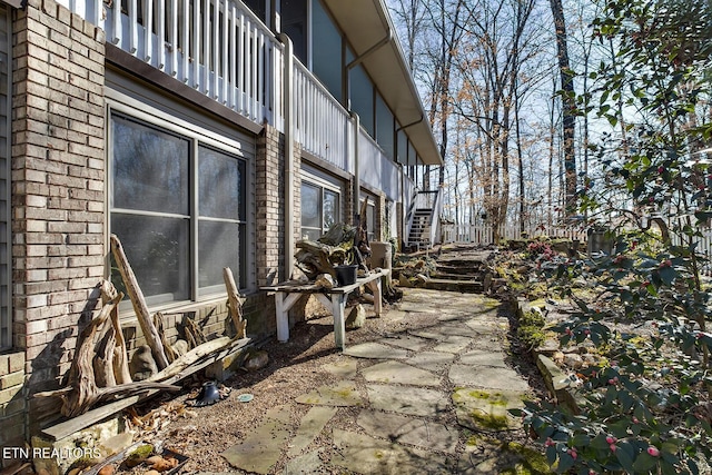 view of side of home with brick siding