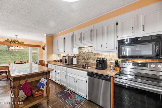 kitchen with light stone counters, stainless steel appliances, tasteful backsplash, white cabinetry, and a sink