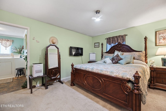 bedroom with baseboards and light colored carpet