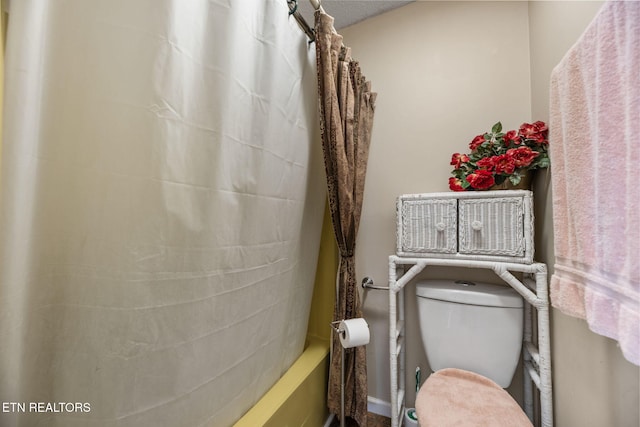 bathroom with toilet and shower / tub combo