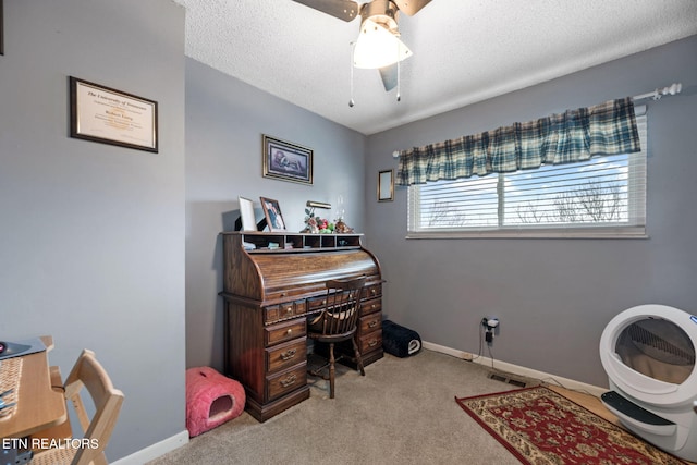 home office featuring a textured ceiling, ceiling fan, carpet flooring, and baseboards