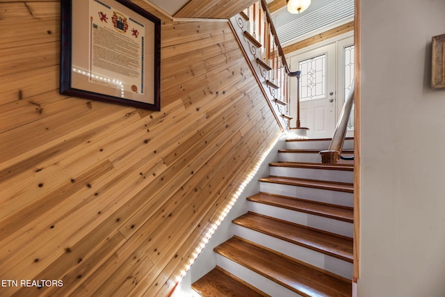 stairway with wood walls