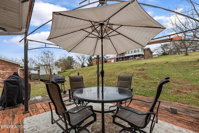 view of patio with a grill and outdoor dining area