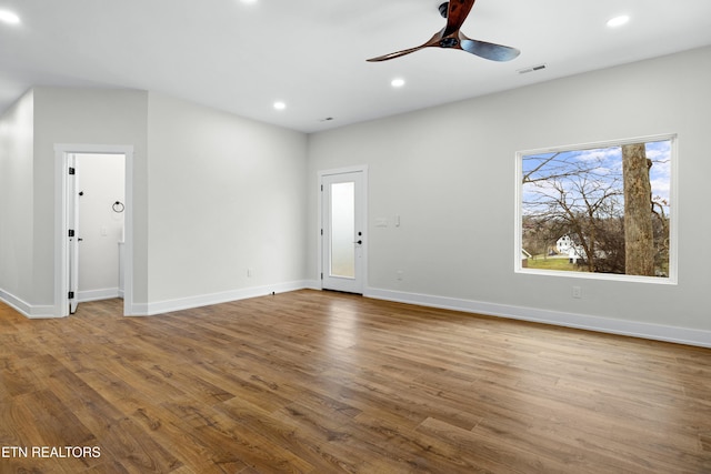 unfurnished living room with recessed lighting, visible vents, baseboards, and wood finished floors